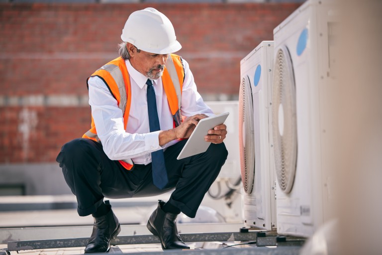 Engineer Conducting Audit On AC Duct