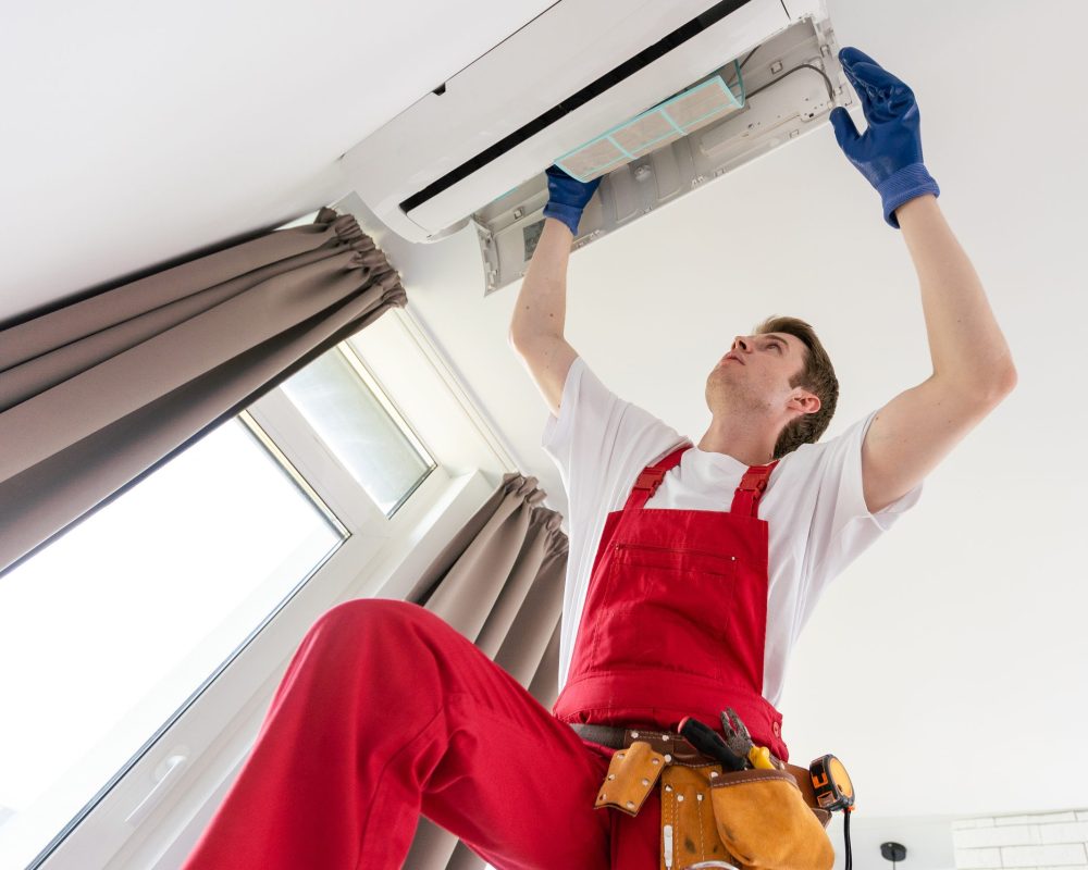 Service man repairing Air Conditioner